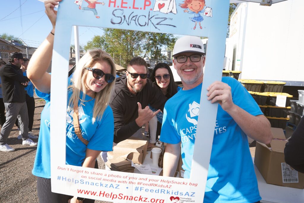 Capstone Contributes volunteers posing at food drive event