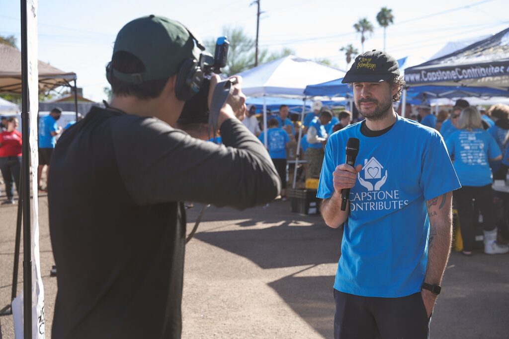 Capstone Contributes volunteer interviewed at community outreach event