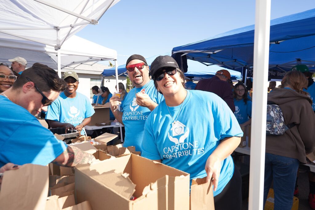 Capstone Contributes volunteers packing donations at community event