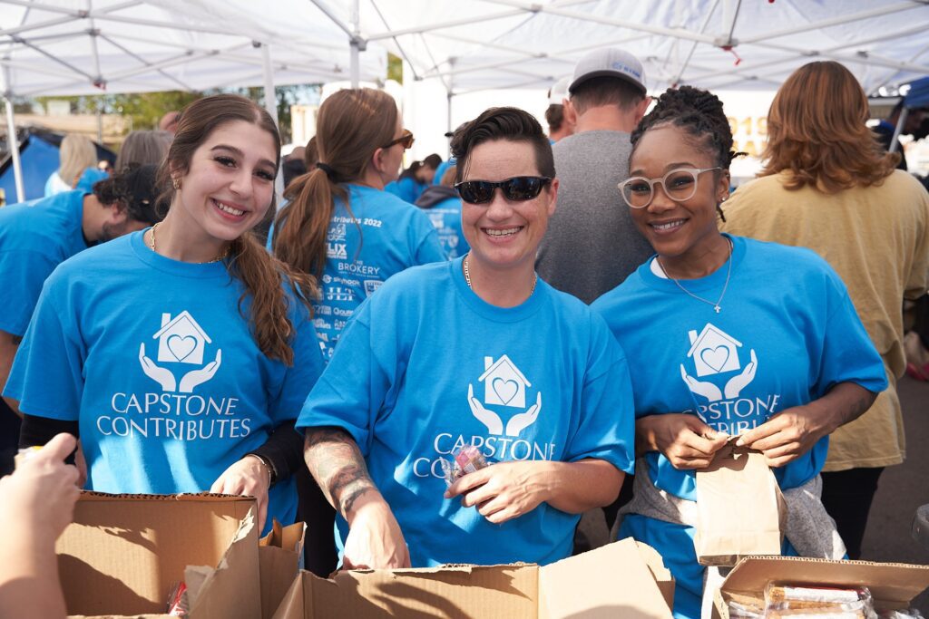 Capstone Contributes volunteers packing donations at community event
