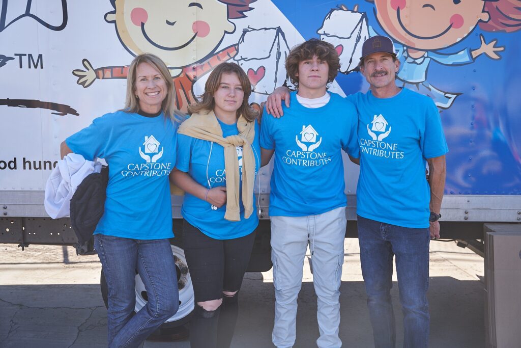 Capstone Contributes volunteers posing at food drive event